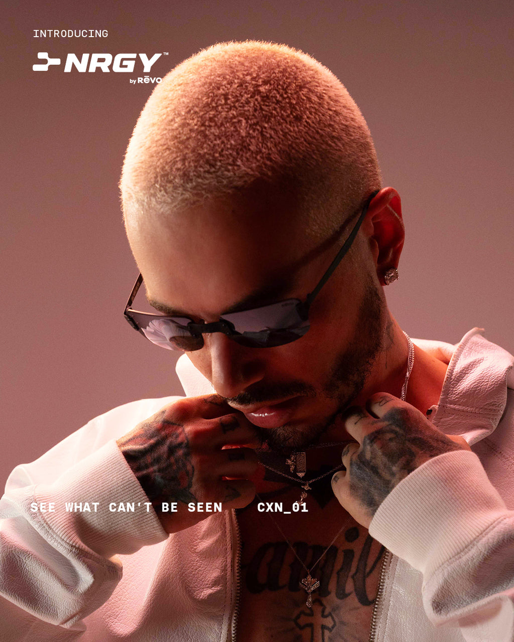 Man in light jacket (J Balvin) looking down to the left  wearing sunglasses